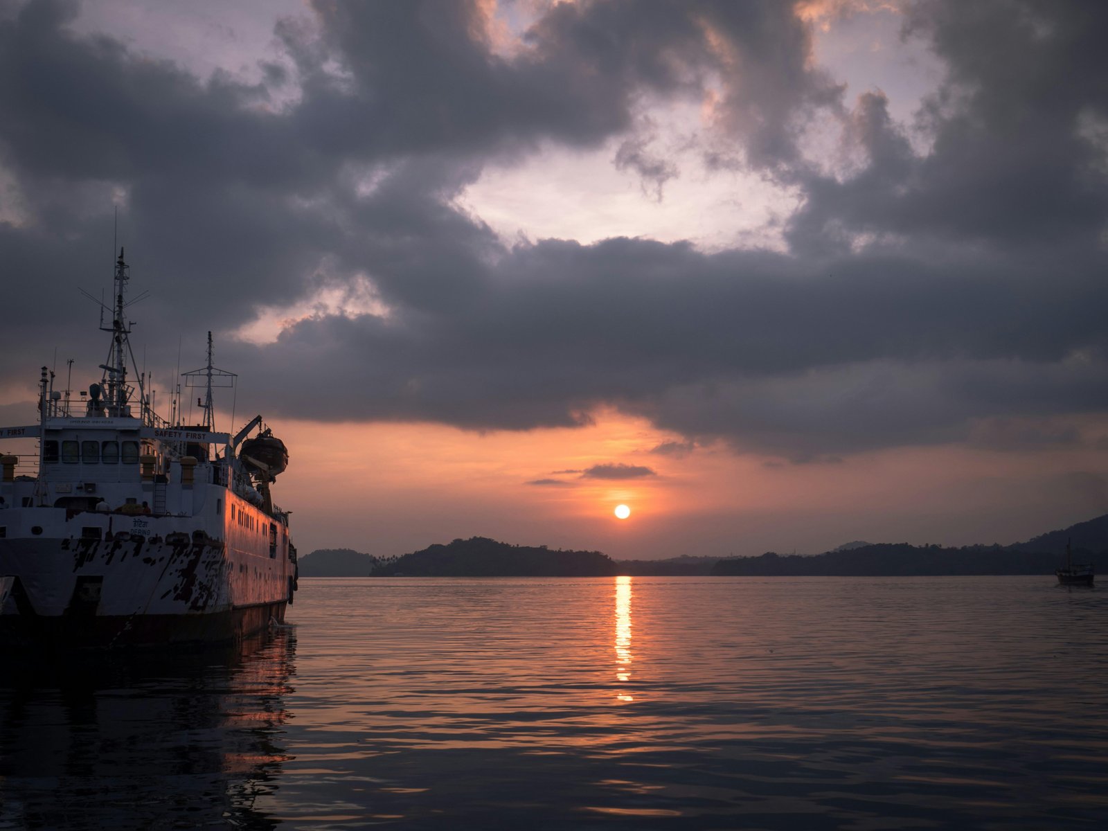 Andaman ferry silhouetted at harbour sunset