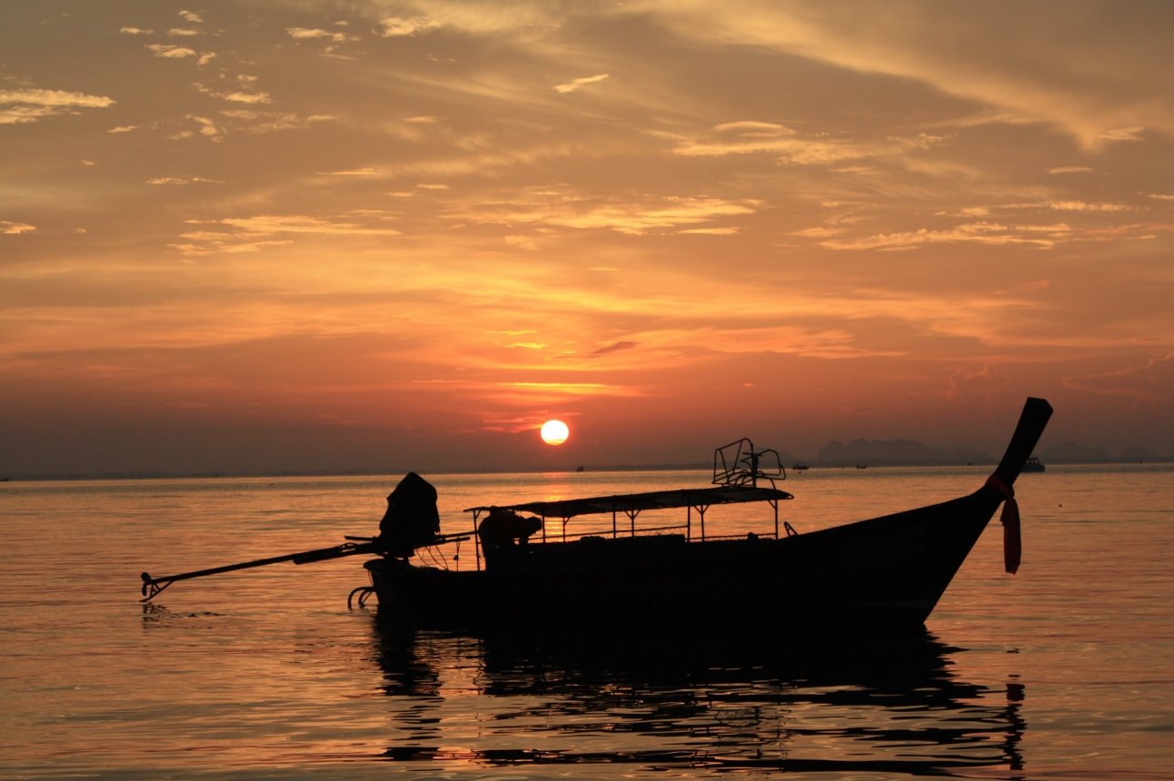 Sunset long-tail boat on calm Andaman waters