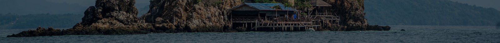 Stilt house by rocks